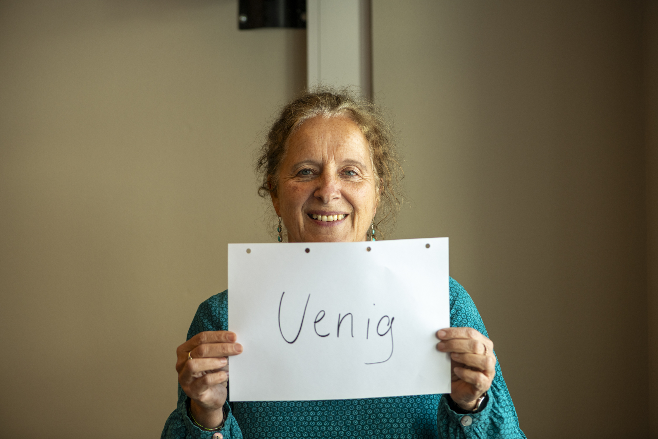 Person holder frem plakat med teksten "uenig" på